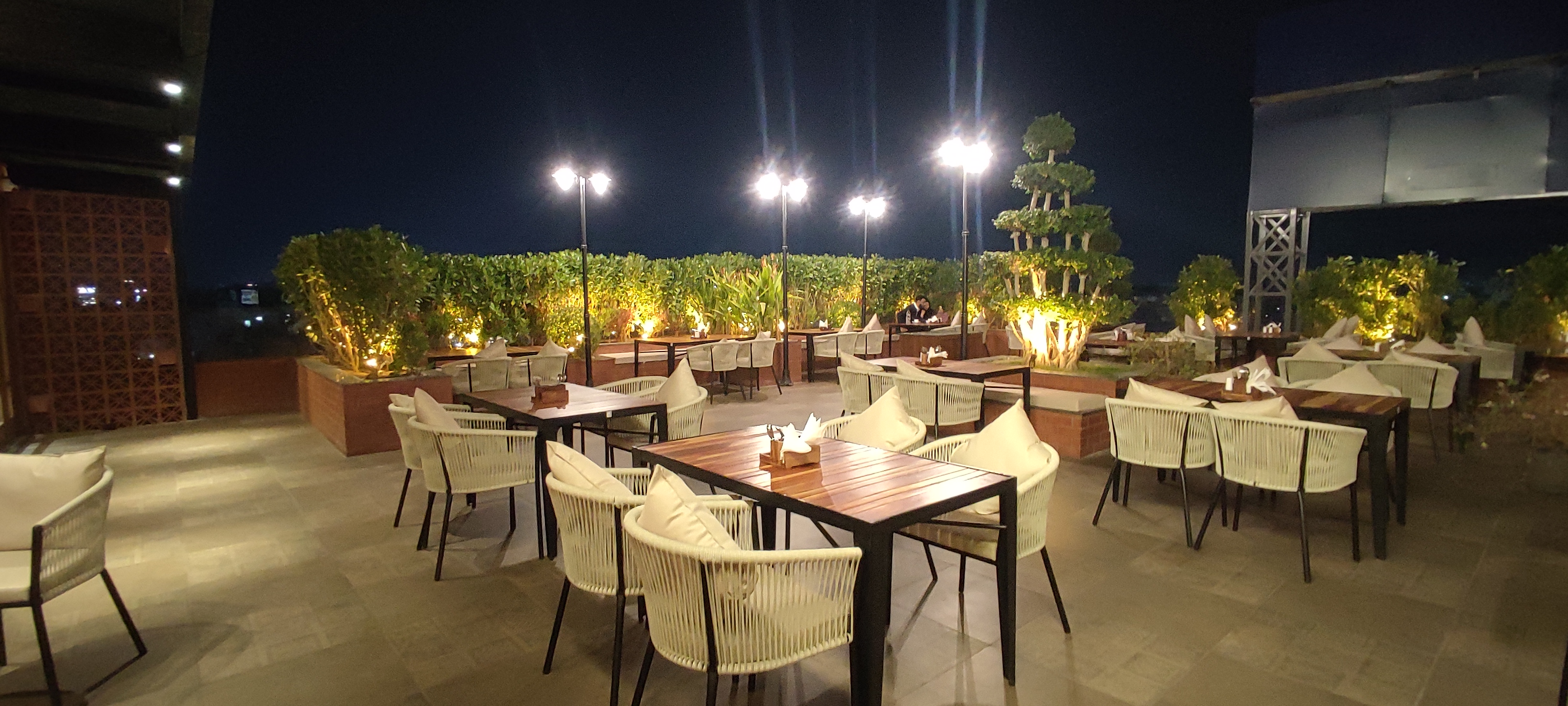 Romantic Moonlit Terrace Lounge Dinner Setup at Tridha Hotels